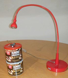 Rote Schreibtischlampe und Erdnussdosen auf Tisch