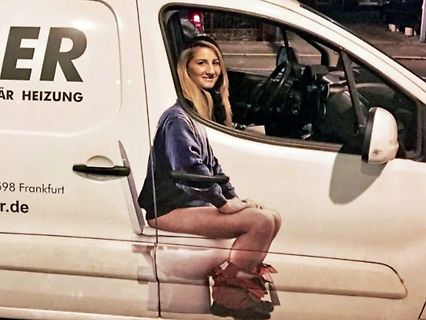 Frau sitzt auf einem weißen Lieferwagen
