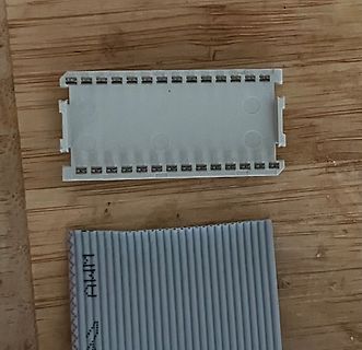 Sockel und Flachbandkabel auf Holzuntergrund