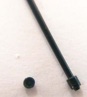 Schwarzer Stab und kleiner runder Gegenstand